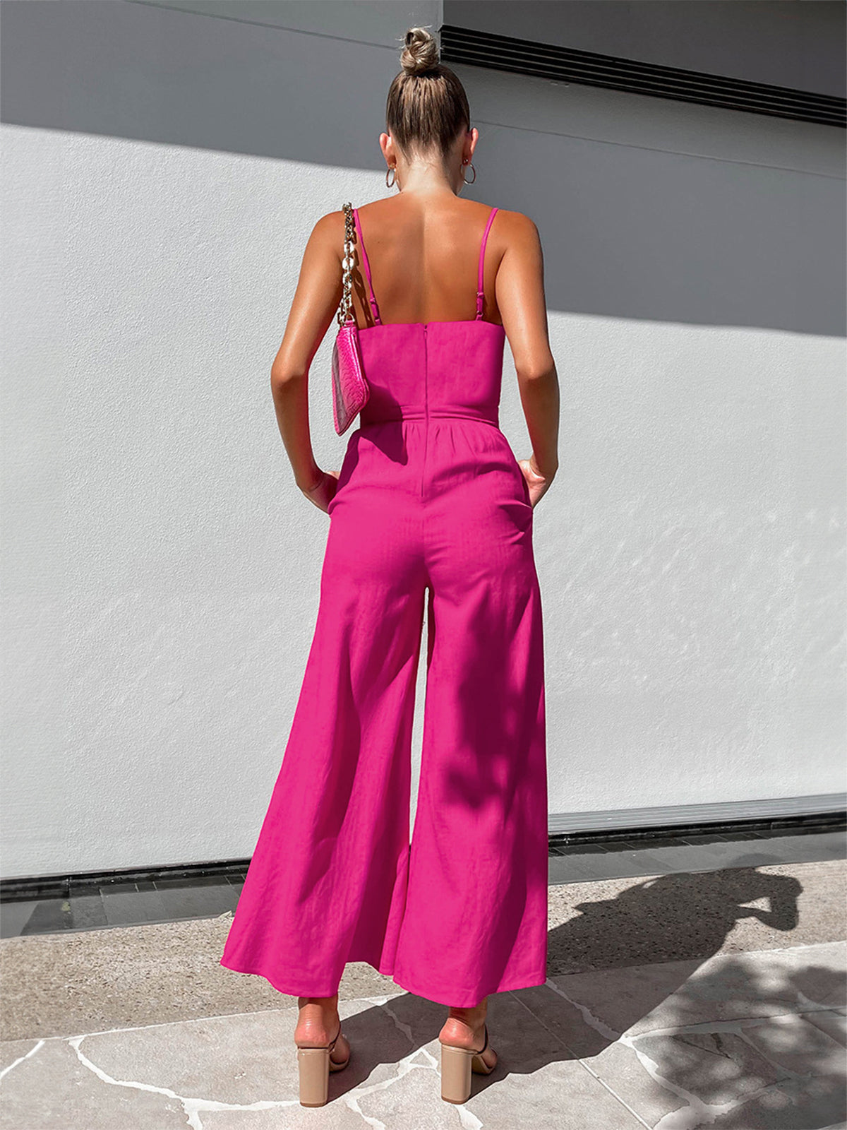 SolŽne Jumpsuit i bomull med vriddetaljer